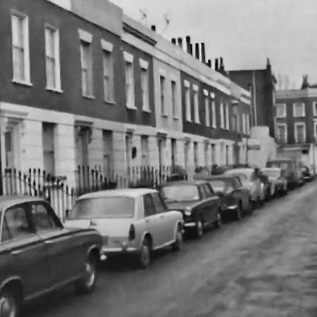 Street of row houses with cars parked along